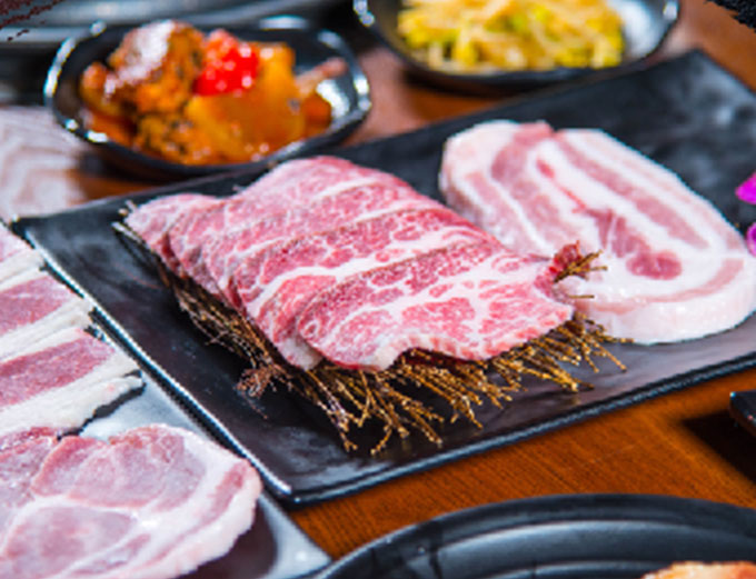 Marbled raw BBQ meats sliced for the grill